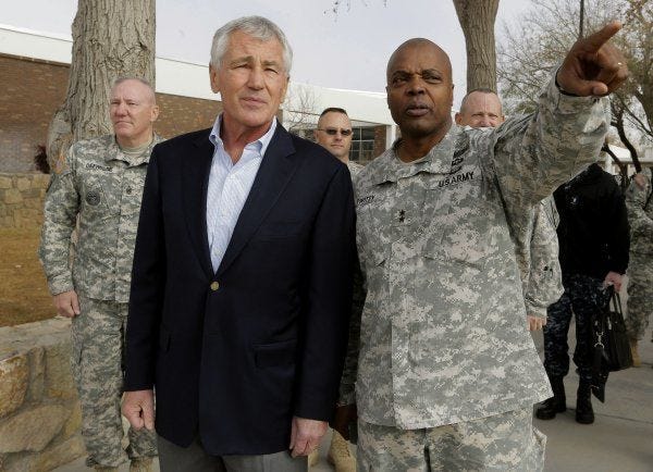 Secretary of Defense Chuck Hagel listens to Maj Gen. Stephen Twitty, commander of Fort Bliss, as he points out some of the newer living quarters on post Thursday.