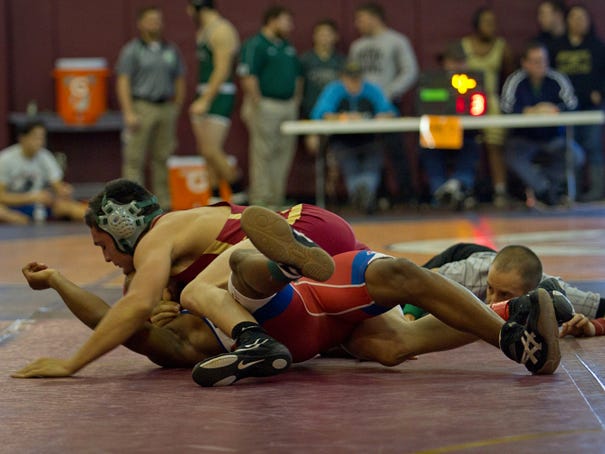 Ashley's Austin Gabriele pins his opponent, Jeff Kornegay, at the Veterans Cup wrestling tournament on Saturday, Jan. 17, 2015.