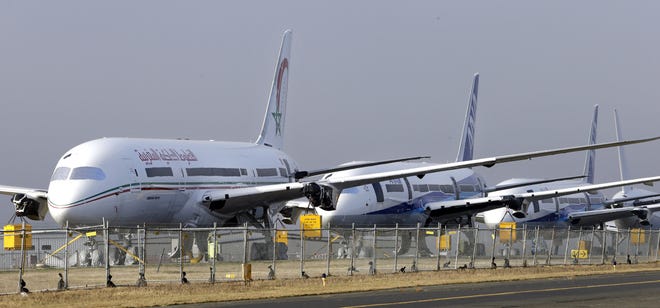 A line of Boeing 787 Dreamliners are parked at Paine Field in Everett, Wash., during assembly in January 2013. A long backlog of orders for new airliners may thin out if carriers react to falling fuel prices by keeping older, less efficient jets in service longer.

Elaine Thompson/Associated Press file