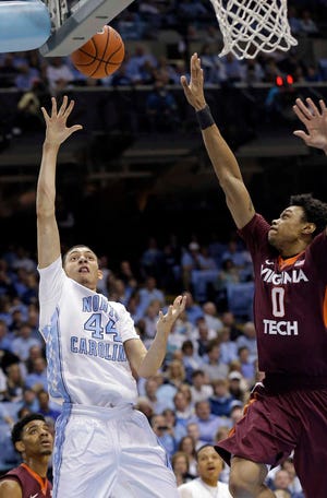 North Carolina's Justin Jackson (44) shoots against Virginia Tech's Shane Henry (0) during the first half of an NCAA college basketball game, Sunday, Jan. 18, 2015, in Chapel Hill, N.C. North Carolina won 68-53. (AP Photo/Gerry Broome)