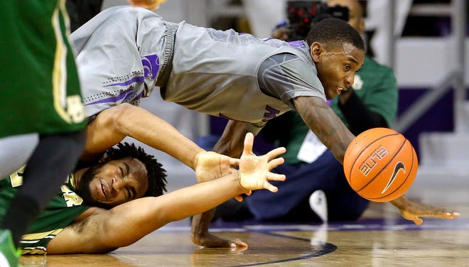 Baylor's Rico Gathers, bottom, and Kansas State's Jevon Thomas chase a loose ball during the second half of an NCAA college basketball game Saturday in Manhattan. Kansas State won 63-61.