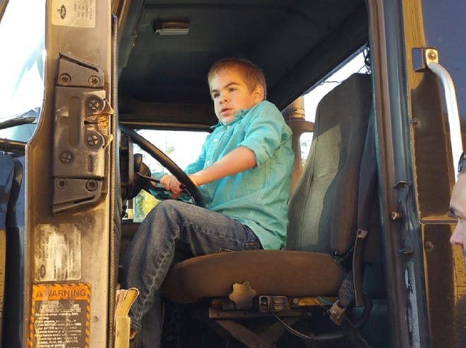Ross Davis sits behind the wheel of a UPS truck.
