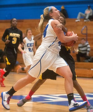 Conwell-Egan Catholic High School's Alyssa Bachik draws a foul from Bishop McDevitt's Savannah Roberts while driving to the basket during the first half of a girls basketball game in Bristol Township Monday night.