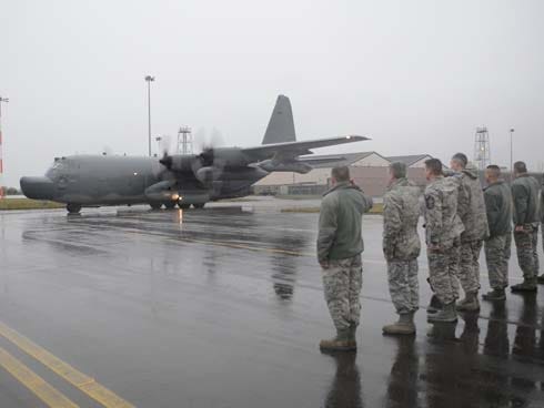 Airmen from the 352nd Special Operations Group and the 100th Air Refueling Wing line Delta Row taxiway Jan. 8, render a final salute as the MC-130H Combat Talon II heads for Hurlburt Field.