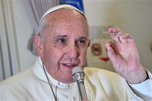 Pope Francis gestures as he talks with journalists during his flight from Manila to Rome, Monday, Jan. 19, 2015. Pope Francis flew home Monday after a weeklong trip to Asia, where he called for unity in Sri Lanka after a civil war and asked Filipinos to be "missionaries of the faith" in the world's most populous continent after a record crowd joined his final Mass in the Philippine capital. (AP Photo/Giuseppe Cacace, pool)
