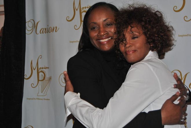 Pat Houston, left, shares a hug with her sister-in-law, Whitney Houston, when Whitney came to Shelby in 2011 for Teen Summit. Star file photo