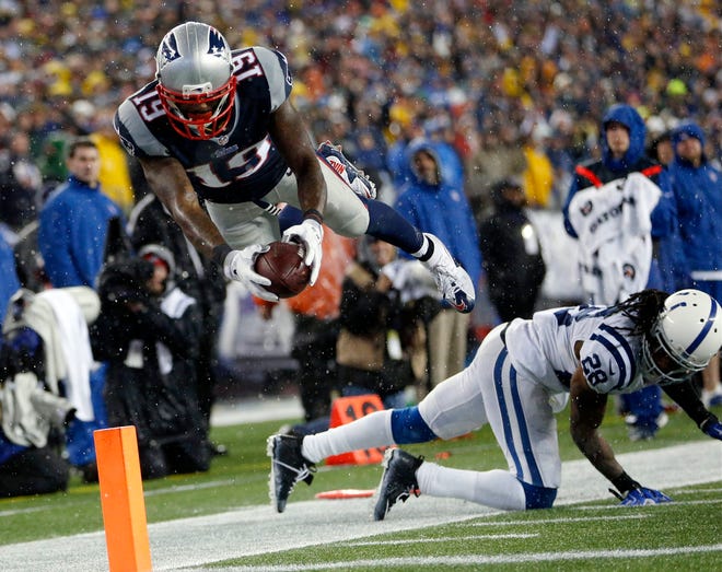 New England's Brandon LaFell dives over Indianapolis' Greg Toler Sunday during the Patriots' 45-7 win in the AFC Championship game. THE ASSOCIATED PRESS