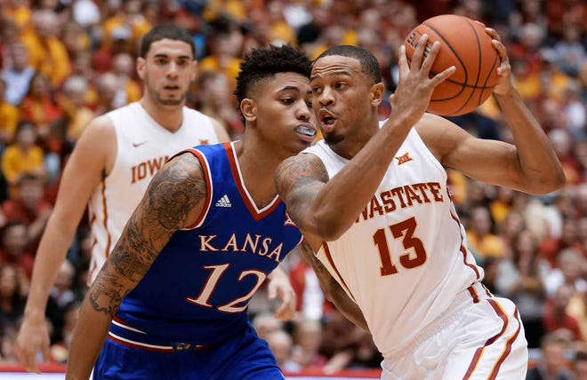 Iowa State guard Bryce Dejean-Jones, right, drives past Kansas guard Kelly Oubre Jr. during the first half of an NCAA college basketball game Saturday in Ames, Iowa.