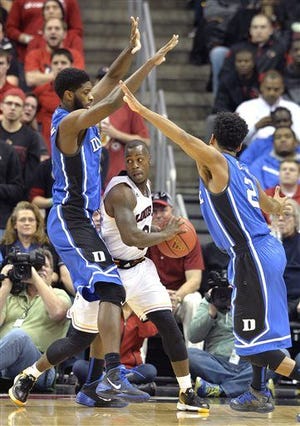 Louisville's Chris Jones is pressured by Duke's Amile Jefferson and Quinn Cook.
