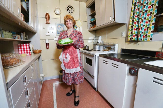 Debbie Segner in character as "Bea," a housewife in the kitchen of a Lustron home that is part of an exhibit about the 1950s at the Ohio History Center.