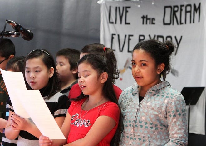 Children in the Germantown Neighborhood Center chorus sing during the Martin Luther King Jr. Day breakfast in Quincy on Monday, Jan. 19, 2015.