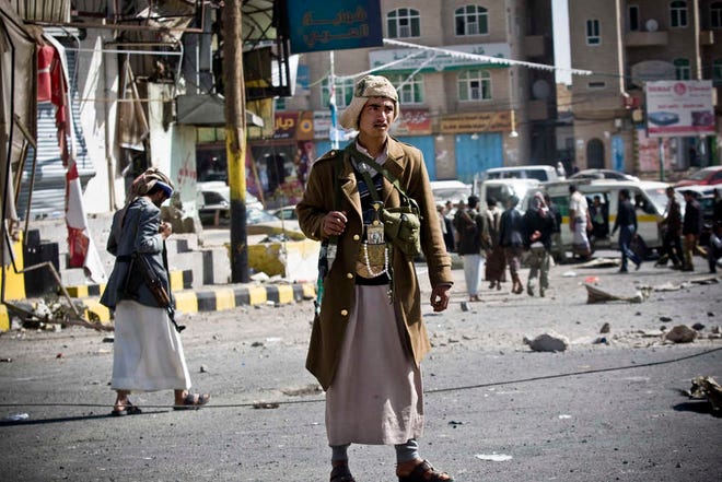 Houthi Shiite Yemeni gather while guarding a street leading to the presidential palace in Sanaa, Yemen, Tuesday, Jan. 20, 2015. Yemen's U.S.-backed leadership came under serious threat Monday as government troops clashed with Shiite rebels near the presidential palace and a key military base in what one official called "a step toward a coup." (AP Photo/Hani Mohammed)