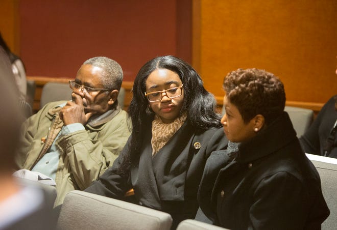 Members of Hyphernkemberly Dorvilier's family, including her mother Juana Sully, right, sit in the back of the courtroom during her initial court appearance via teleconference at the Burlington County N.J. Courthouse in Mount Holly, N.J., Tuesday, Jan. 20, 2015. Dorvilier is accused of killing her newborn baby by immolation. The judge maintained her $500,000 bail, which was set after police found the baby in flames Jan. 16 in the middle of a residential road. (AP Photo/The Philadelphia Inquirer, Ed Hille, Pool)