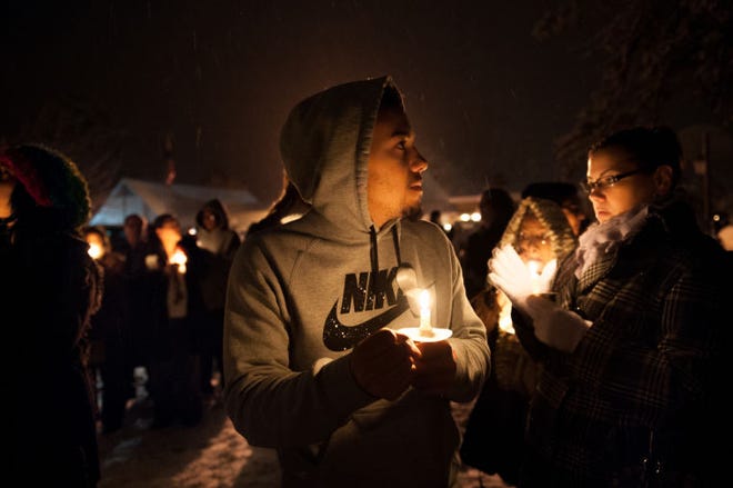 Antoine Wilson, 16, of Pemberton, watches a balloon lit in remembrance drift into the sky outside of the church. A service and candlelight vigil was held for the Browns Mills community at the Browns Mills United Methodist Church Wednesday evening in memory of the baby who died earlier this week after being set on fire by its mother.