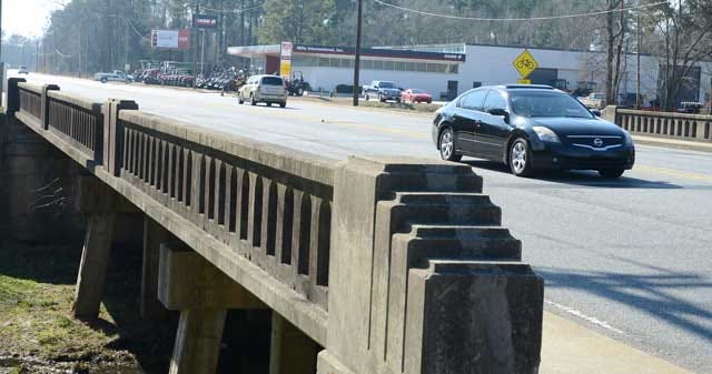 Cars travel over the Queen Street Bridge on Wednesday, just past Springhill Street. Two city-owned lots inside the area will be affected during construction of the Queen Street Bridge replacement project and the Kinston City Council granted easements for the process.