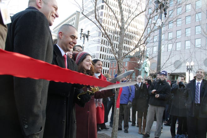 Mayor Jorge Elorza cuts the ribbon Tuesday at the ceremonial reopening of a renovated Kennedy Plaza bus hub in downtown Providence.