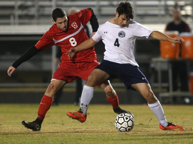 Arnold’s Drew Morros (4) fights for the ball with Bay’s Hunter Hall.