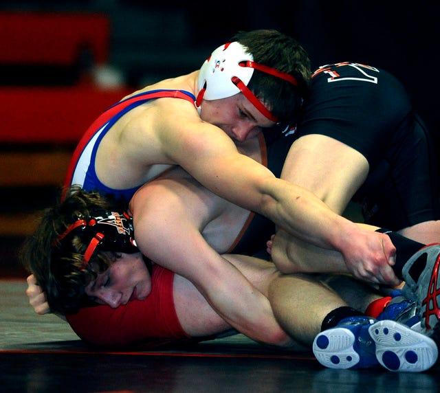 Ames High School's Conner Christensen, bottom, works against Marshalltown's Tristan Traylor during their match at 126 pounds Thursday at Ames High School. Photo by Rich Abrahamson/Special to the Tribune 
 Ames High's Hank Swalla, top, bears down on Marshalltown's Hector Hernandez during their match at 182 pounds Thursday at Ames High School. Photo by Rich Abrahamson/Special to the Tribune