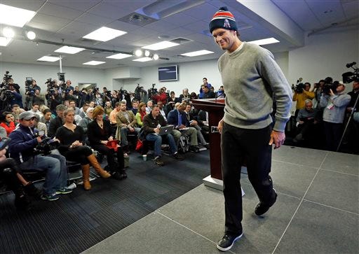 New England Patriots quarterback Tom Brady steps away from a news conference in Foxborough, Mass., Thursday, Jan. 22, 2015. Brady said Thursday that he did not know how New England ended up using underinflated balls in its win Sunday against the Indianapolis Colts in the AFC Championship game.