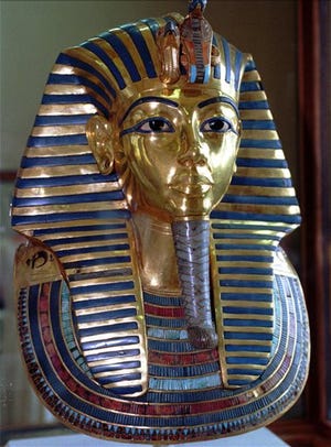 This July 1996 photo shows the mask of King Tutankhamun at the Egyptian Museum in Cairo. On Wednesday, conservators at the museum say the blue and gold braided beard on the artifact was hastily glued back on with epoxy after it was detached during a cleaning.