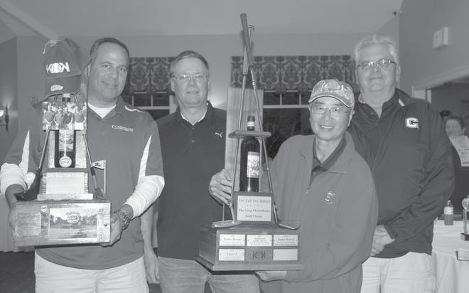 (From left) Mike McDonagh, Scott Buckley, David Wong and Mark Noack of “ICS 1” took first place in the 2014 One Ball Two Strikes Greg Montalbano Golf Classic. The tournament’s two-tiered walnut trophy features a bottle of Chianti Montalbano, which the late pitcher autographed while still playing professional baseball.