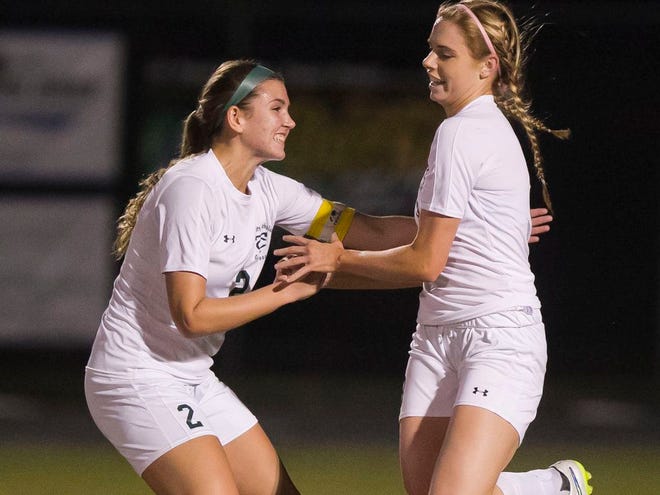 Trinity Catholic's Dorothy Hellman (2) congratulates teammate Laura Hamilton (8) on her goal in the first half. Trinity defeated visiting Eastside 1-0 on Thursday night in the girls soccer regional quarterfinals.