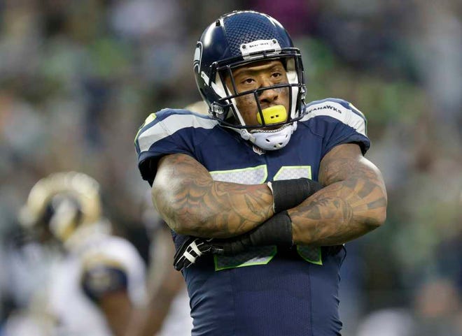 FILE - This Dec. 28, 2014, file photo shows Seattle Seahawks linebacker Bruce Irvin reacting after he broke up a pass attempt by St. Louis Rams quarterback Shaun Hill in the second half of an NFL football game in Seattle. Once thought to be a risky first-round draft pick and a one-trick pony in the NFL that could only rush the passer, Bruce Irvin has developed into a defensive player that never leaves the field. (AP Photo/Scott Eklund, File)