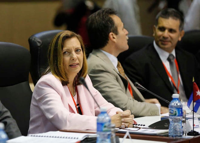 Ministry of Foreign Relations General Director for the United States, Josefina Vidal, and Cuban delegation members, sit across from U.S. delegates as they begin negotiations, in Havana, Cuba, Wednesday, Jan. 21, 2015. The highest-level U.S. delegation to Cuba in decades kicked off two days of negotiations Wednesday after grand promises by President Barack Obama about change on the island and a somber warning from Cuba to abandon hopes of reforming the communist government. (AP Photo/Desmond Boylan)