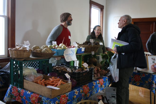 Ben and Hannah Wolbach, owners of Skinny Dip Farm in Westport, showcase some of their winter harvest for their neighbors and potential customers at the recent Meet Your Local Farmer event held at the Westport Grange. Michael Gagne/Herald News