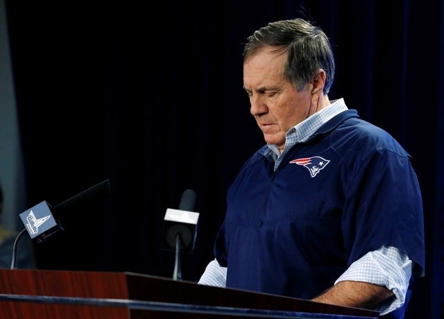 New England Patriots head coach Bill Belichick reads from notes as he speaks during a news conference prior to a team practice in Foxboro this morning. Belichick addressed the issue of the NFL investigation of deflated footballs. (AP Photo/Elise Amendola)