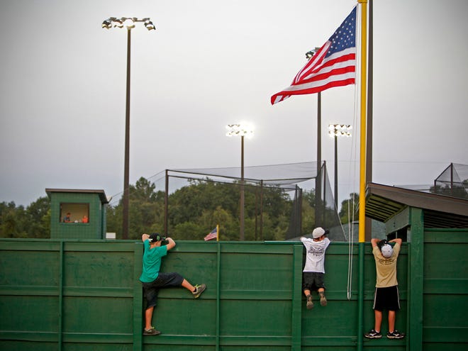 In this June 30, 2012 file photo, young fans stand on the outfield wall to watch a game during the inaugural baseball tournament for Nations Park in Newberry.