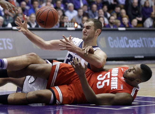 Northwestern center Alex Olah and Ohio State center Trey McDonald wrestle over a loose ball during the first half.