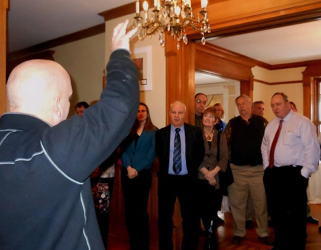Jim Smith, whose back is to the camera, explains some of the detailing of the trim by the ceiling to members of the Intercounty Legislative Committee of the Adirondacks at the Overlook Mansion on Thursday. Smith is the innkeeper of the bed and breakfast. TELEGRAM PHOTO/STEPHANIE SORRELL-WHITE