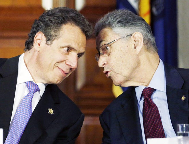 In this June 19, 2014 file photo, New York Gov. Andrew Cuomo, left, and Assembly Speaker Sheldon Silver, D-Manhattan, talk during a news conference announcing an agreement on legislation legalizing medical marijuana in Albany. Even after his arrest on federal corruption charges, Silver remains one of the most powerful politicians in New York. His fellow Democrats, with a dominant two-thirds Assembly majority, are standing behind him so far, while the new legislative session begins and causes he has championed are on the table. AP PHOTO/MIKE GROLL
