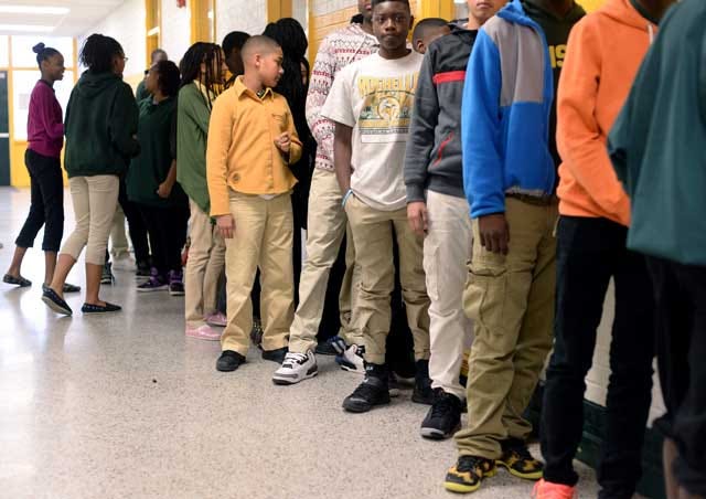 Students line up outside the cafeteria at Rochelle Middle School on Friday. The school’s current dress code calls for tan, black or blue khaki pants and white, yellow or green shirts with exceptions made on Fridays.