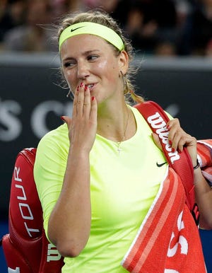 Victoria Azarenka of Belarus smiles as she leaves the court after defeating Caroline Wozniacki of Denmark in their second round match at the Australian Open tennis championship in Melbourne, Australia, Thursday, Jan. 22, 2015. (AP Photo/Lee Jin-man)