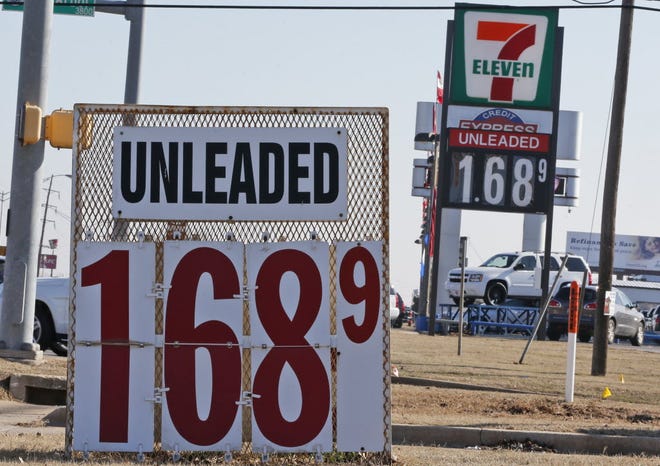 Signs at two gas stations advertise unleaded gasoline in Oklahoma City Friday.