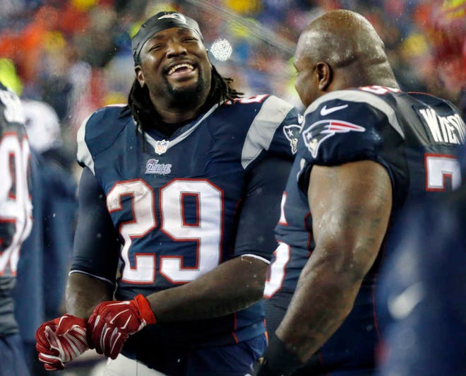 New England Patriots running back LeGarrette Blount (29) celebrates with defensive tackle Vince Wilfork during the second half of the NFL football AFC Championship game against the Indianapolis Colts Sunday, Jan. 18, 2015, in Foxborough, Mass. (AP Photo/Elise Amendola)