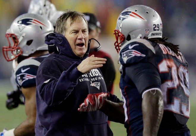 New England Patriots head coach Bill Belichick congratulates LeGarrette Blount after his touchdown during the second half of the NFL football AFC Championship game against the Indianapolis Colts Sunday, Jan. 18, 2015, in Foxborough, Mass. (AP Photo/Charles Krupa)