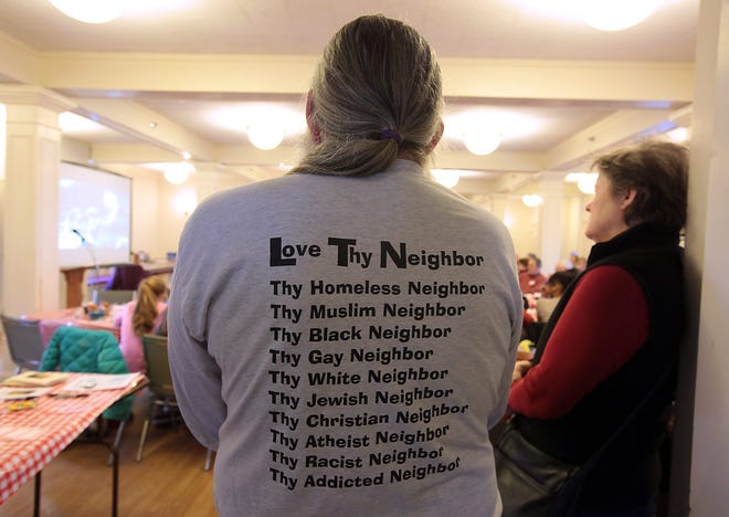 A Cohasset resident wears a T-shirt with a message about love at a 2015 MLK Day breakfas.