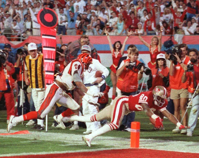San Francisco 49ers receiver Jerry Rice, right, dives into the end zone for a touchdown during the third quarter in Super Bowl XXIII against Cincinnati.