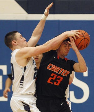 Andy Nelson/The Register-Guard
Springfield’s Gabe Sorber (left) fouls Crater’s Dean Orozco late in the game on Friday.