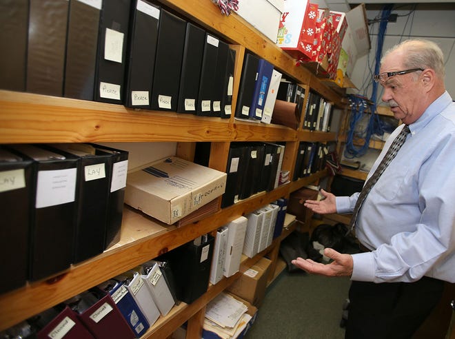 Former Panama City Beach Police Chief Lee Sullivan looks through cold cases at the Bay County Sheriff’s Office.