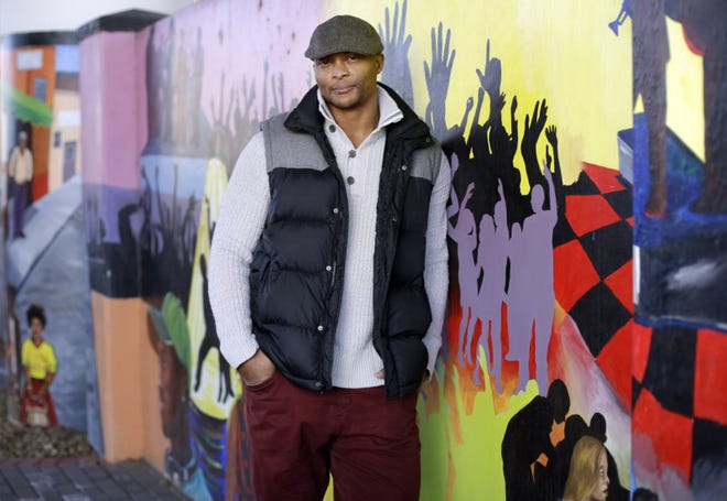 Former Tennessee Titans running back Eddie George poses for photos at an urban improvement project designed and constructed by his landscape and design company, The Edge, in Nashville, Tenn. George is one of many pros who become entrepreneurs after their playing days were over. (AP Photo/Mark Humphrey)