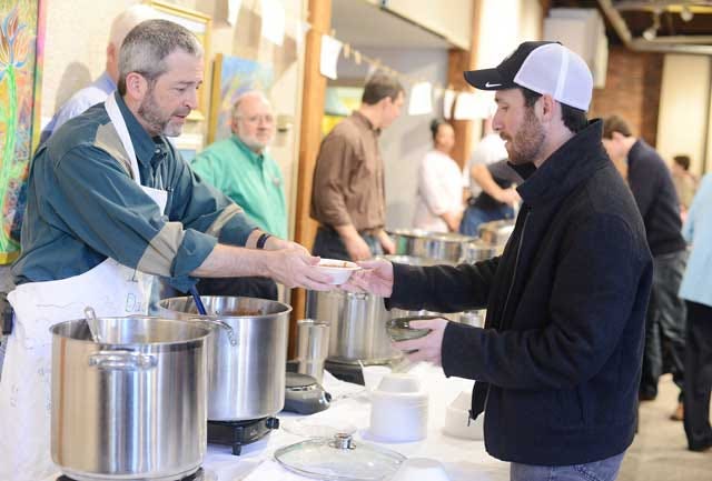 Stuart Stroud serves soup to David McKenna Sunday at the Community Council for the Arts’ 16th annual Soup and a Bowl at the arts center.