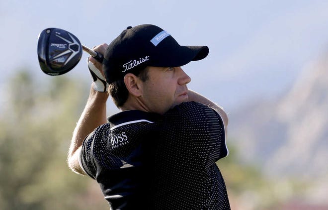 Erik Compton watches his tee shot on the first hole during the third round of the Humana Challenge golf tournament on the Nicklaus Private course at PGA West on Saturday, Jan. 24, 2015 in La Quinta, Calif. (AP Photo/Chris Carlson)