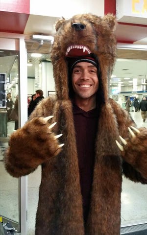CICERO GONCALVES, dressed in grizzly bear garb, looks to be well-prepared for snowy weather as he waits in New York's Penn Station for a train to Vermont on Sunday. Goncalves was headed north for some snowboarding, and was traveling by train because he expected the flight he had hoped to take would be canceled because of a storm that could dump 2 to 3 feet of snow from starting today. Goncalves, a 34-year-old flight attendant from Queens, counted himself and his travel partner as lucky. "We'll get there before it snows, and we're coming back when the storm is over, on Thursday," he said.