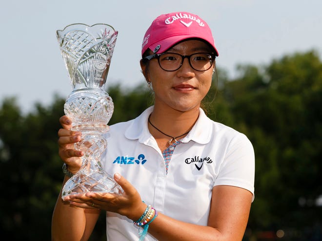 Lydia Ko, of New Zealand, holds up her trophy after winning the Marathon Classic at Highland Meadows Golf Club in Sylvania, Ohio, last July.
