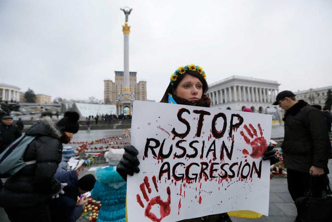 Sergei Chuzavkov/The Associated PressA woman holds a placard on Sunday during a rally on Independence Square in Kiev, Ukraine.
