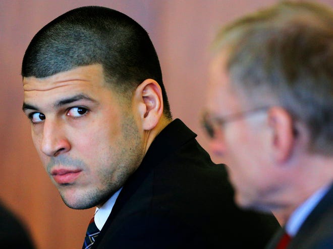 FILE - In this Dec. 22, 2014 file photo, former New England Patriots tight end Aaron Hernandez, left, attends a pretrial hearing in Fall River, Mass. Hernandez is accused of murdering semi-professional football player Odin Lloyd. A jury is expected to be seated for opening arguments in his murder trial as early as Tuesday, Jan. 27, 2015.